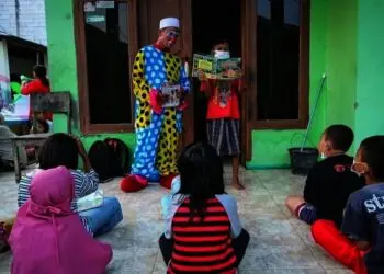 Badut Berkeliling Mengajak Anak-anak Membaca Buku