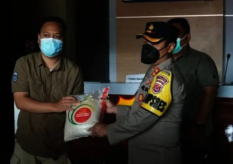 BERI BANTUAN–Kapolres Pandeglang, AKBP Hamam Wahyudi, secara simbolis memberikan bantuan sembako ke seorang wartawan di lingkungan Mapolres Pandeglang, Rabu (28/7/2021). (NIPAL SUTIANA/SATELITNEWS.ID)