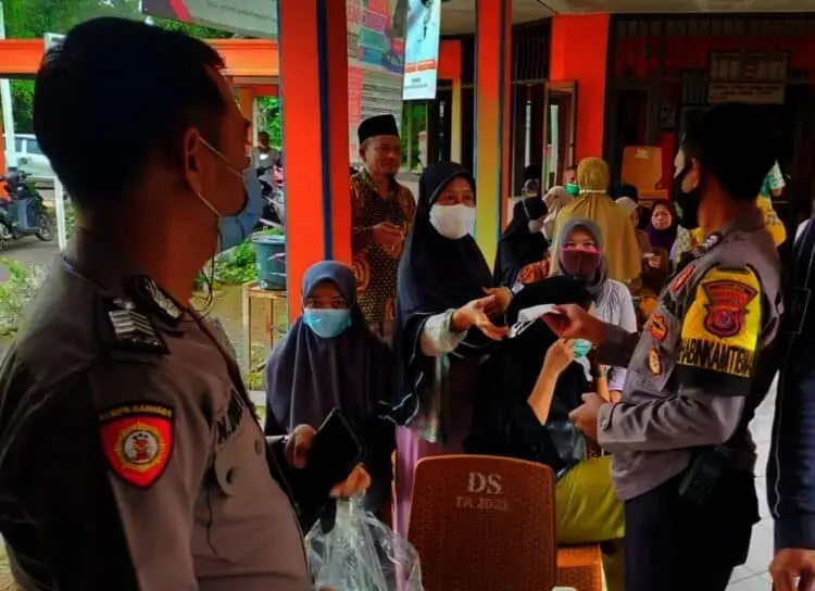 BAGIKAN MASKER–Dalam kesempatan kegiatan vaksinasi, jajaran personel Polsek Pagelaran bagikan masker dan ajak warga terapkan prokes, Jumat (17/9/2021). (ISTIMEWA)