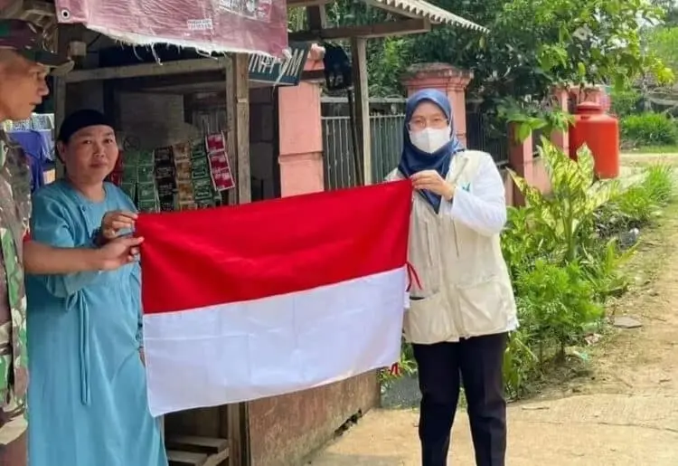 Pegawai Puskesmas Patia Kabupaten Pandeglang Bagikan Bendera Merah - Putih ke Warga