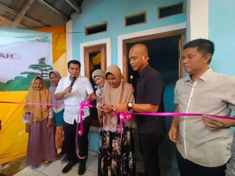 PERESMIAN BEDAH RUMAH: Warga Desa Muncung, Kecamatan Kronjo, Darina didampingi Sekda Kabupaten Tangerang, Moch. Maesal Rasyid dan Kepala Kejaksaan Tinggi DKI Jakarta, Reda Manthovani memotong pita peresmian bedah rumah, Minggu (9/4). (ALFIAN HERIANTO)