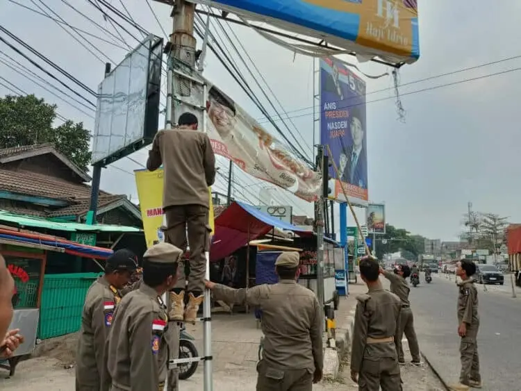 Personel Dinas Satpol-PP Kabupaten Serang, tertibkan APK dan APS yang dianggap melanggar dan carut marut, Senin (2/10/2023). (SIDIK/SATELITNEWS.COM)