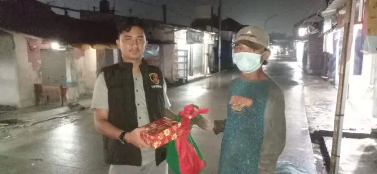 Petugas kepolisian, memberikan bingkisan sembako kepada masyarakat, disela - sela kegiatan patroli, Rabu (13/3/2024). (ISTIMEWA)