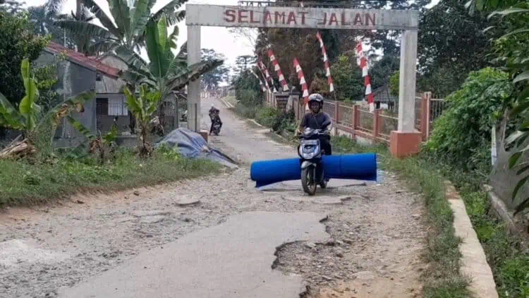 Seorang pengendara sepeda motor, melintas di ruas jalan Cicadas - Pasirpeuteuy - Kaduengang, yang kondisinya rusak berat, Selasa (11/6/2024). (ADIB FAHRIE/SATELITNEWS.COM)