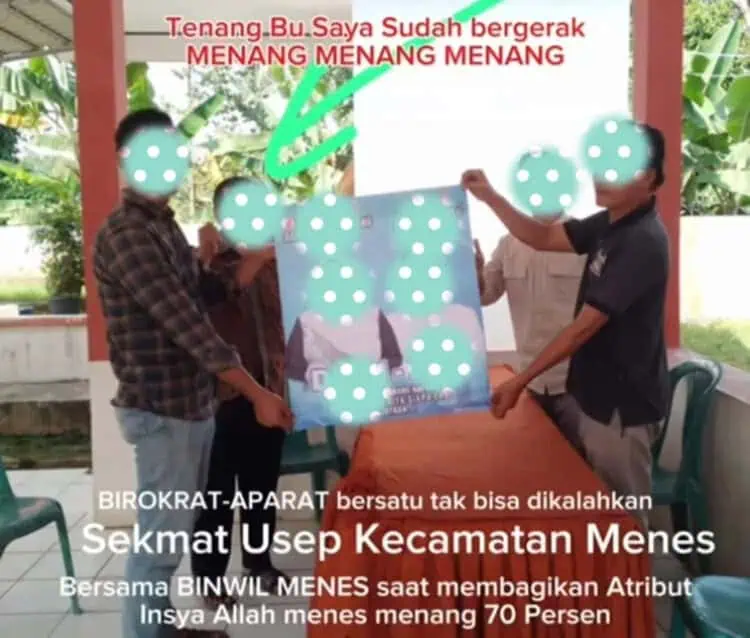 Dua orang yang diduga ASN di lingkungan Pemkab Pandeglang, memegang poster Pasangan Balon Bupati dan Wakil Bupati Pandeglang. (ISTIMEWA)