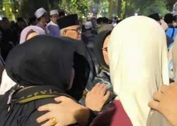 Salahsatu pengantar jamaah haji, yang tidak kuasa menahan tangis saat saudaranya berangkat menunaikan rukun Islam ke lima, di Pendopo Pemkab Lebak, Kamis (14/5/2026) malam. (MULYANA/SATELITNEWS.COM)