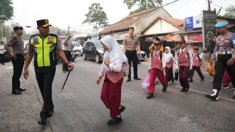MENYEBRANGKAN ANAK SEKOLAH : Kapolda Banten Irjenpol Hendra Kurniawan, menyebrangkan anak sekolah dalam kegiatan Gatur pagi di SDN Banjarsari 2. (ISTIMEWA)
