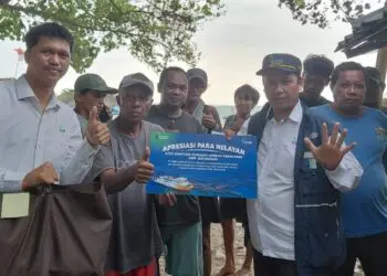 MEMBERIKAN PAKET SEMBAKO : Petugas PT ASDP Merak, Radmiadi (kanan), memberikan paket sembako kepada para nelayan yang membantu melakukan evakuasi penumpang KMP Batumandi. (ISTIMEWA)